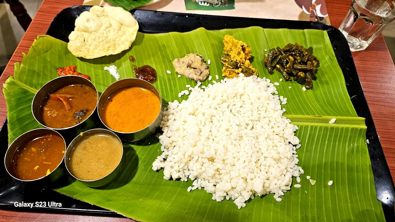 Slow Malabar rice plated with curries on a banana leaf